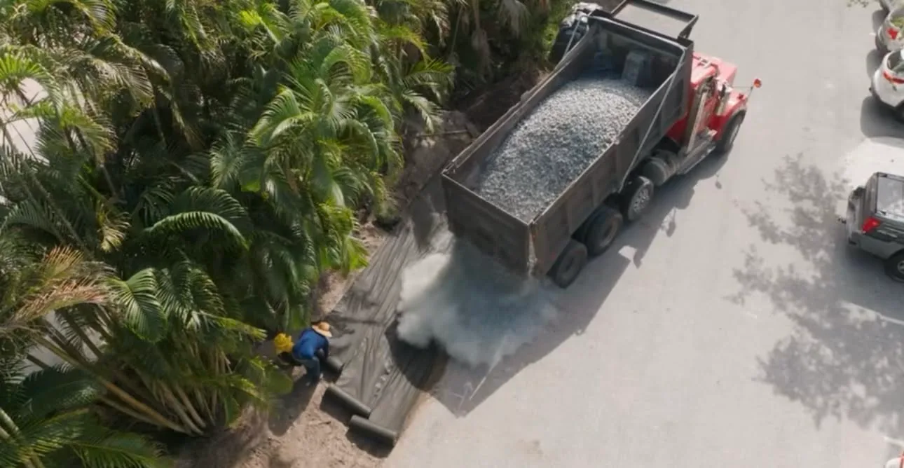 Dump truck delivering bulk material on a job site